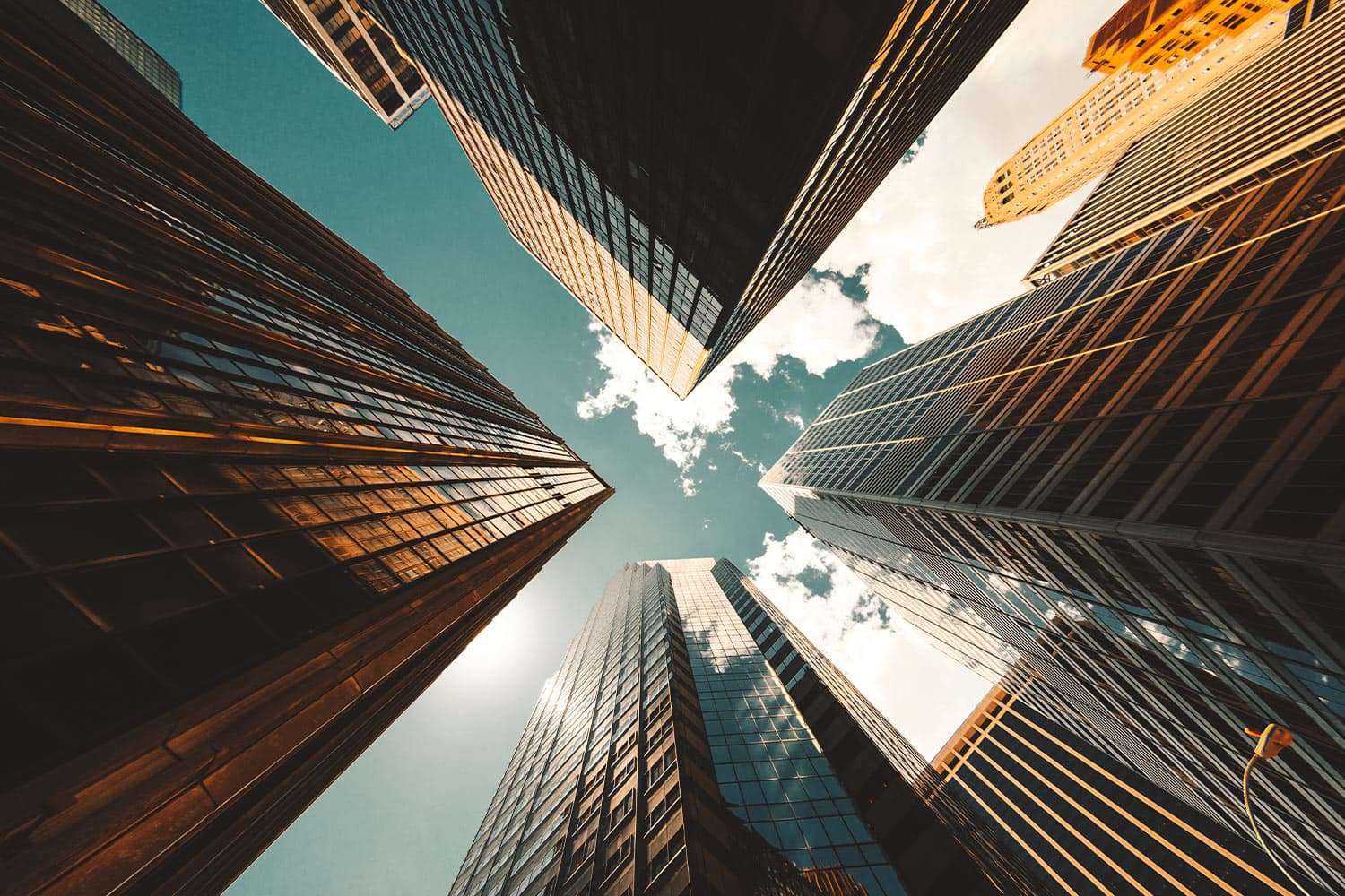 High-rise towers converging against the sky