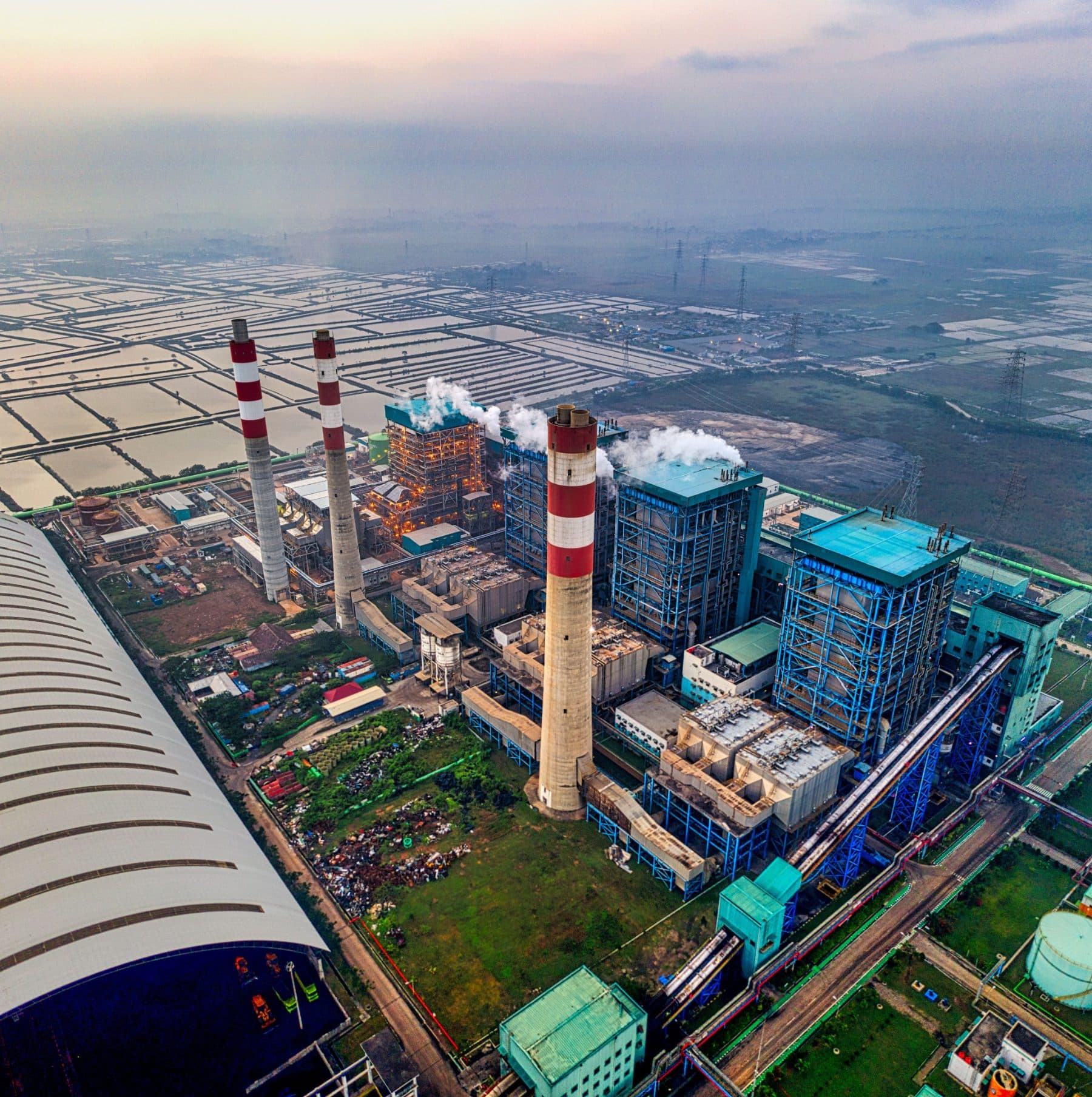 Aerial view of a coastal industrial complex at dusk