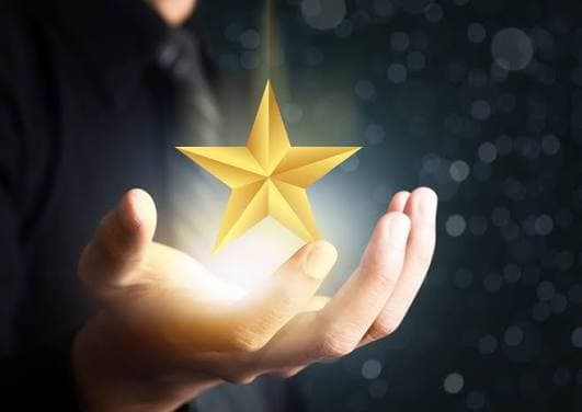 Open hand holding a glowing star